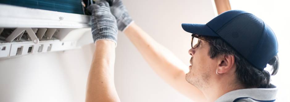 homme en pleine réparation d’un système de VMC